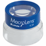 Una lente de aumento azul y transparente etiquetada como "MacroLens 4.5X" por LaMotte, diseñada para visión cercana, se coloca sobre una superficie blanca. Model MacroLens - 5508 ofrece precisión y claridad para una inspección detallada.